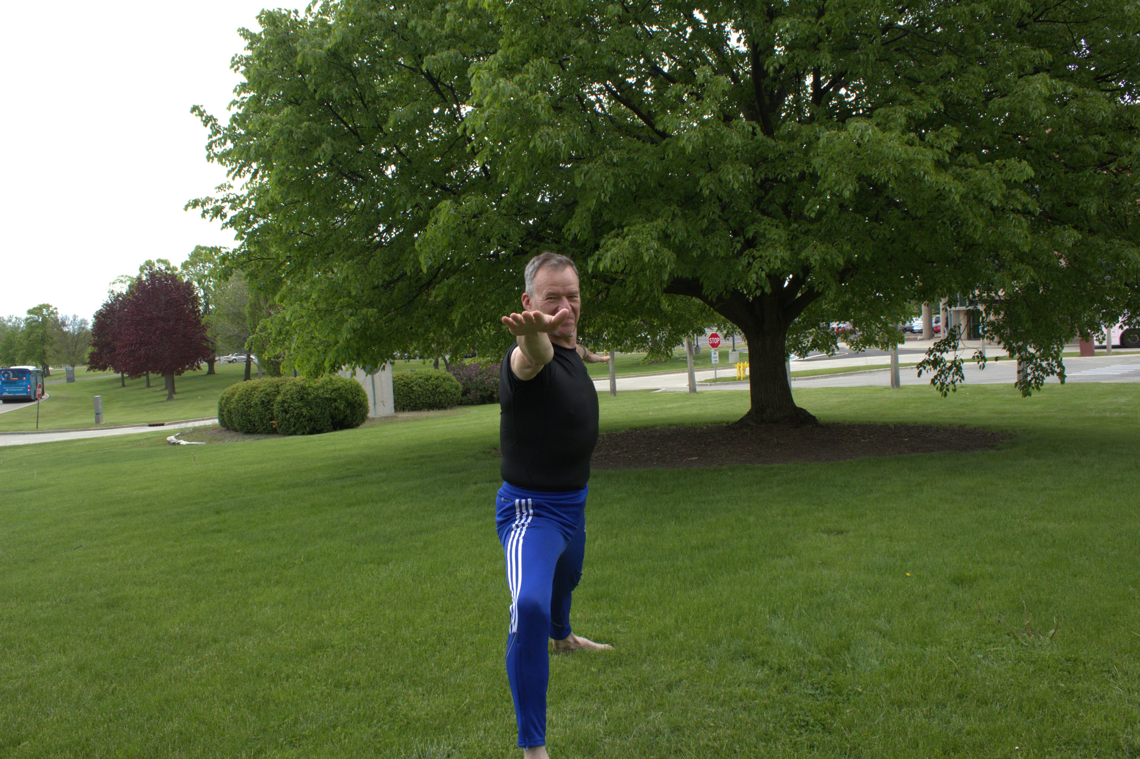 Roy practising Warrior Two pose outdoors